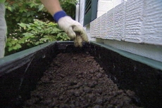 layering soil in the window box planter