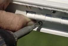 using a self-centering bit to install the storm door