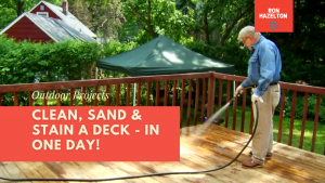 Man spraying deck with house