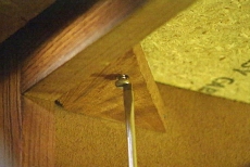 loosening fasteners beneath the kitchen countertop
