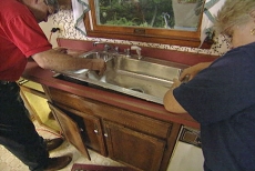 dropping the sink into the kitchen countertop cutout