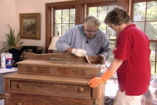 examining the stains on the antique furniture