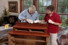 wiping excess stain off the antique furniture