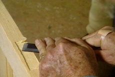 Using the chisel to clean the high spots from the hinge mortise