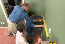 ensuring the decorative wall frame panels are plumb and level
