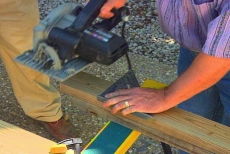 cutting wooden components with circular saw and combination level