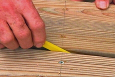 spacing deck planks with a carpenter's pencil