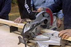 cutting two-by-four framing with a power saw