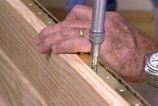drilling pilot holes through the piano hinges