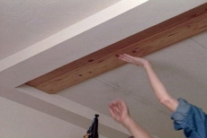 Installing the tongue and groove planks to create a solid ceiling panel
