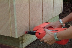 covering the wall frames with exterior sheathing