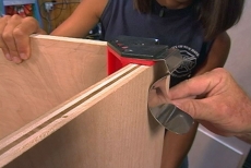 Using a joiner clamp to hold the sides in place