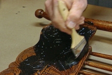 glazing the details of the antique chair
