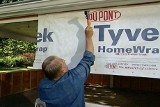 Tacking Tyvek housewrap on the exterior to weatherproof the new room