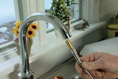 inserting the spray nozzle into the kitchen faucet