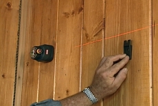 aligning wall cabinet clips with a laser level