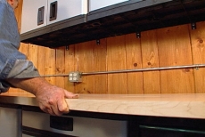 positioning the hardwood countertop in the garage workshop
