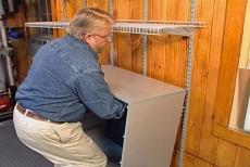 inserting the hanging cabinet grips into the shelf standards