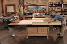 sliding the plywood bottom into the under-bed storage drawer