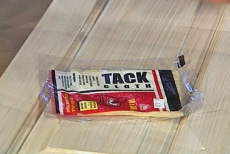 Using tack cloth to wipe away dust