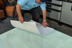 Applying fiberglass paper to the Thin-Skin Adhesive