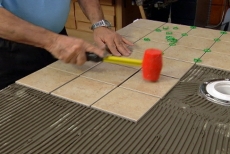 Setting tile with a plastic mallet