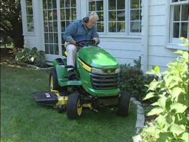 mowing the lawn with a riding mower