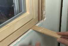 inserting shims to level the retro-fit window