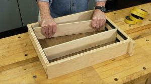 Man Adjusting Wooden Drawer Dividers