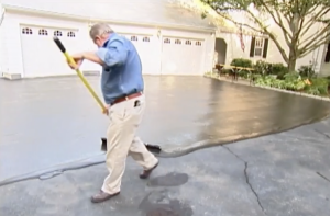 Man resurfacing a driveway
