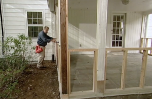 Man building wood frame for four season room