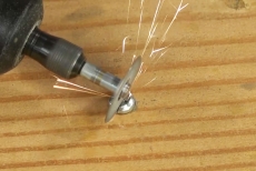 Cutting slot in screw with rotary tool 