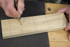 Drawing a hole with a pencil on piece of wood