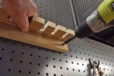 Man using screwdriver to mount a tool board