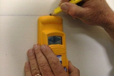 locating wall studs with an electronic stud finder