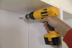 drilling through the hanging strip into the wall stud