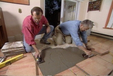 troweling the thin-set mortar for the tile floor