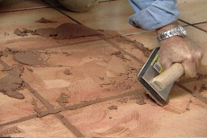 raking grout diagonally on the tile floor