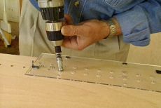 using a pre-drilled plastic template