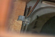 unscrewing the metal clips beneath the sink