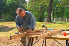tapping the dowel into position with a mallet