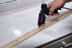 applying glue to the back of the decorative molding