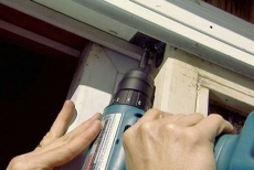 removing the top bracket from the stationary door