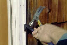 removing nails with a nail puller and hammer