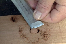 popping out the cut plug with a chisel