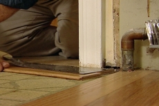 undercutting the door casing prior to installing planks beneath