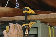 clamping the gas heater to a joist along its mounting flange