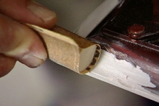 using sandpaper to smooth the wood filler