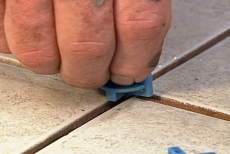 Pressing a Tavy Tile Spacer into a joint