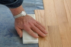 Using a plastic block to tap a stubborn piece into place
